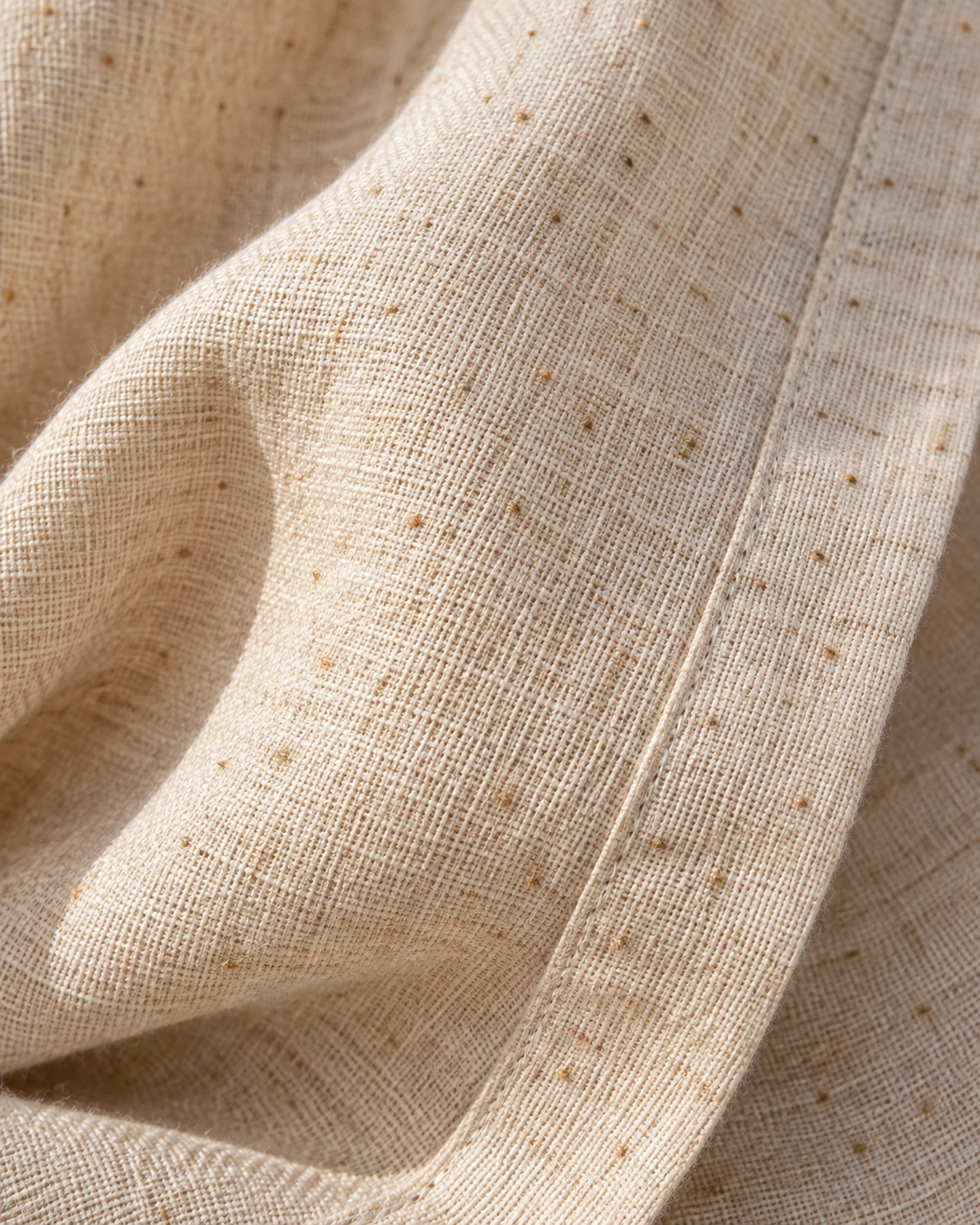 Kimono Pavia en crudo con bordado rojo, en macro, la textura del material