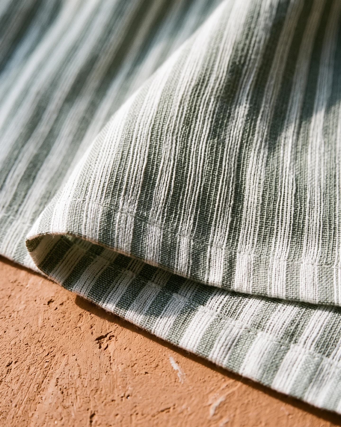 Pantalón Playa Bahita en rayado blanco y verde, en macro, la textura del material